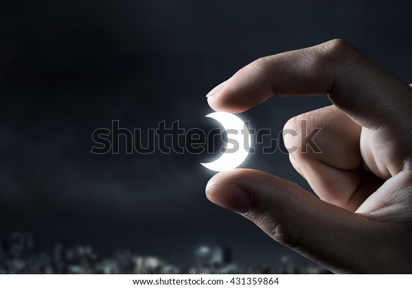 moon-between-fingers-600w-431359864.jpg