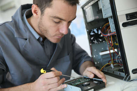 37490473-technician-fixing-computer-hardware.jpg