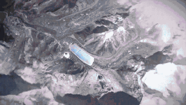 an aerial view of a mountain range with a few mountains in the background
