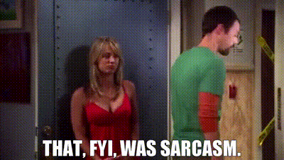 a man and a woman are standing next to each other in a doorway . the woman is wearing a red dress .