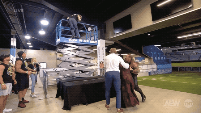 kenny-omega-scissor-lift-moonsault.gif