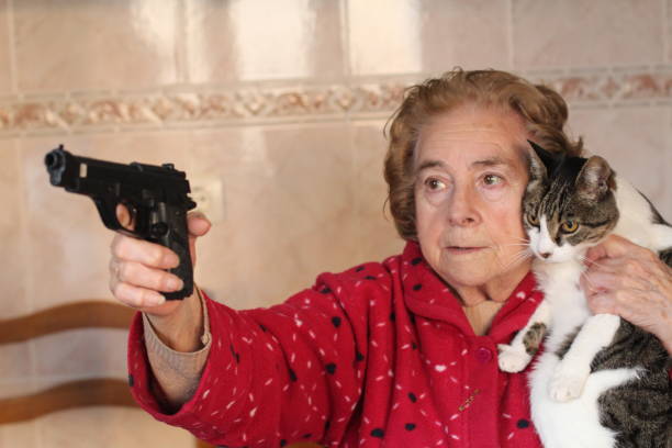 angry-senior-woman-protecting-her-cat-with-a-gun.jpg